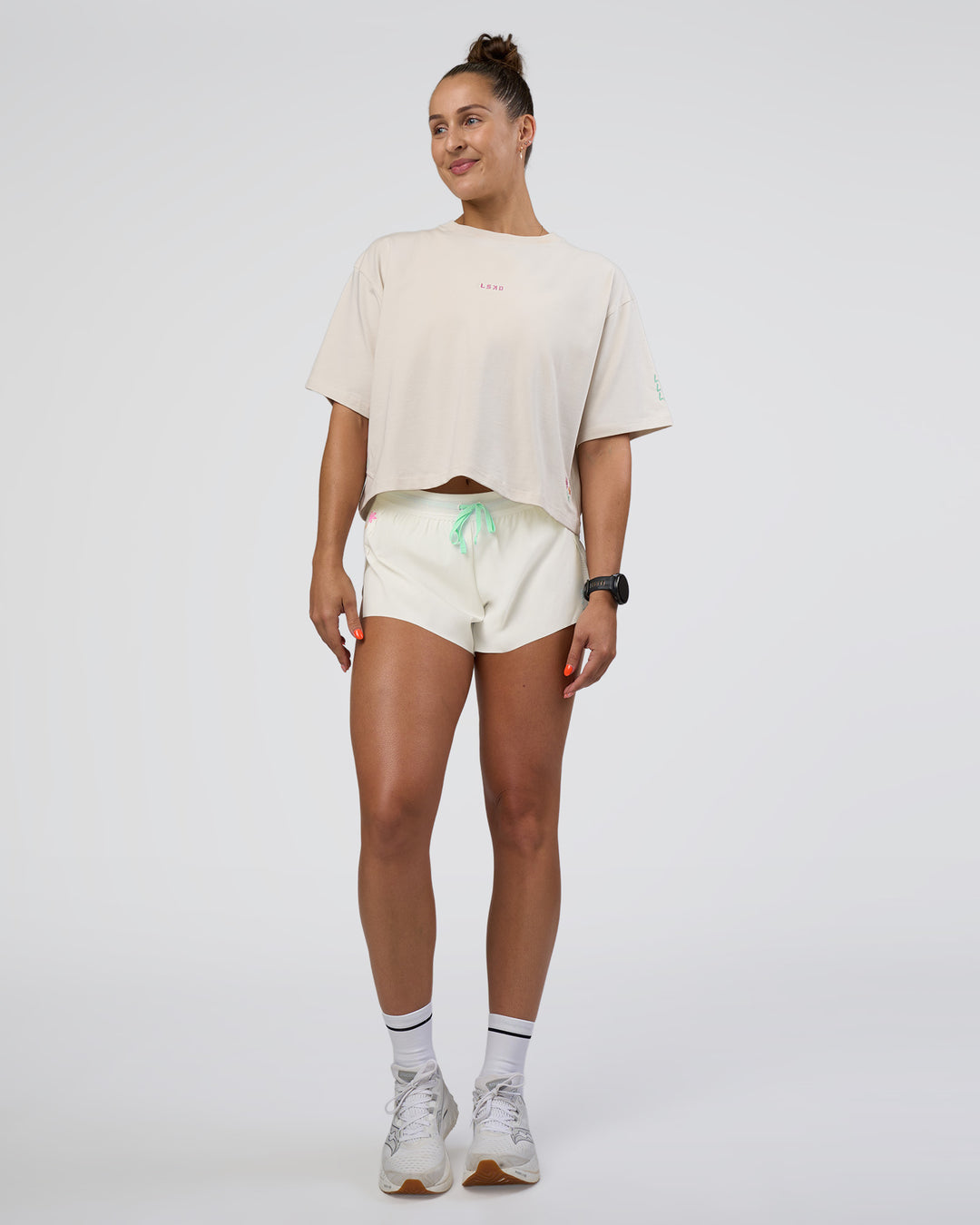 Woman wearing Accelerate 3&quot; Mid-Rise Running Short - Off White-Floral Sticker | Model:Abbey | Size:S