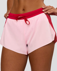 Woman wearing Accelerate 3" Mid-Rise Running Short - Scarlet-Marshmallow | Set:true | Angle:closeup | Model:Amity | Size:S