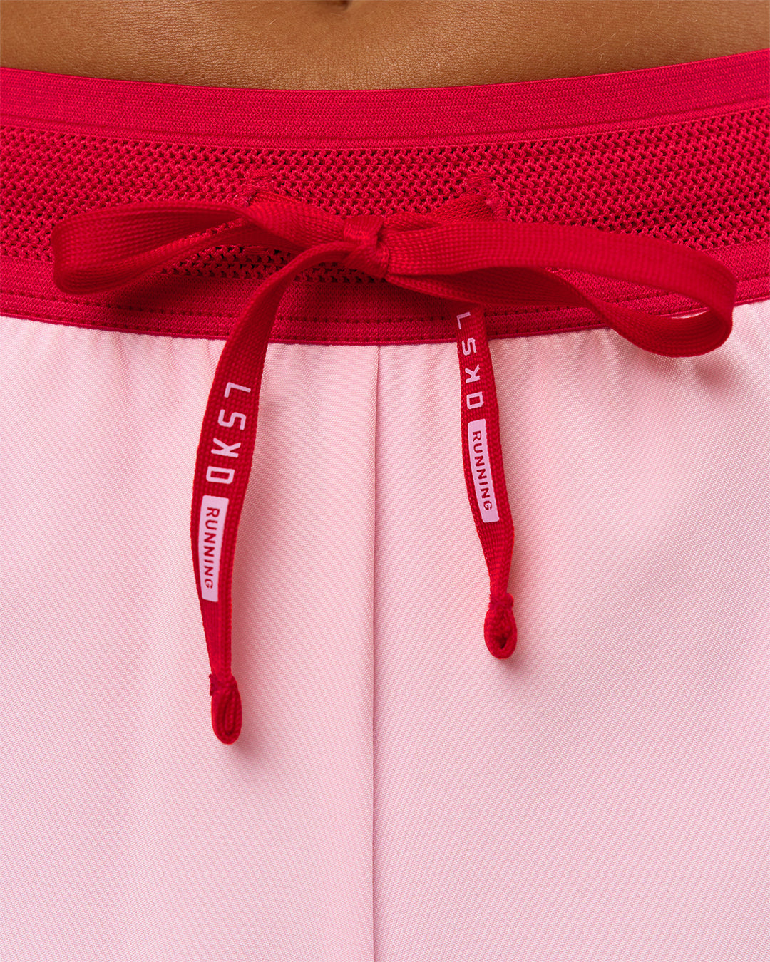 Woman wearing Accelerate 3" Mid-Rise Running Short - Scarlet-Marshmallow | Model:Amity | Size:S