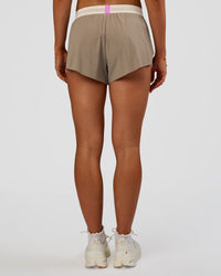 Woman wearing Accelerate 3" Mid-Rise Running Short - Taupe Ash-Glacial Blue | Set:true | Angle:back | Model:Emelia | Size:S