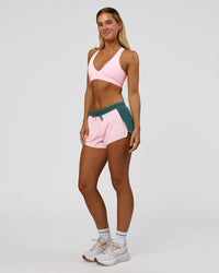 Woman wearing Accelerate 3" Mid-Rise Running Short - Transformative Teal-Marshmallow | Model:Amity | Size:S