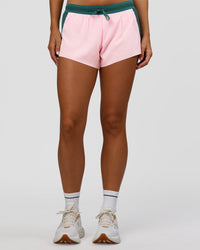Woman wearing Accelerate 3" Mid-Rise Running Short - Transformative Teal-Marshmallow | Set:true | Angle:front | Model:Amity | Size:S