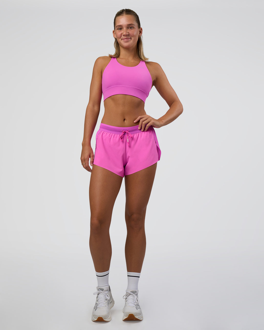 Woman wearing Accelerate 3&quot; Mid-Rise Running Short - Ultra Fuchsia | Model:Amity | Size:S