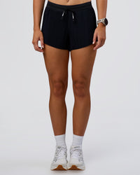 Woman wearing Accelerate 3" Pleated Mid-Rise Running Short - Black  | Set:true | Angle:front | Model:Emelia | Size:S