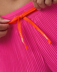 Woman wearing Accelerate 3" Pleated Running Short - Ultra Pink | Model:Rhiley | Size:S