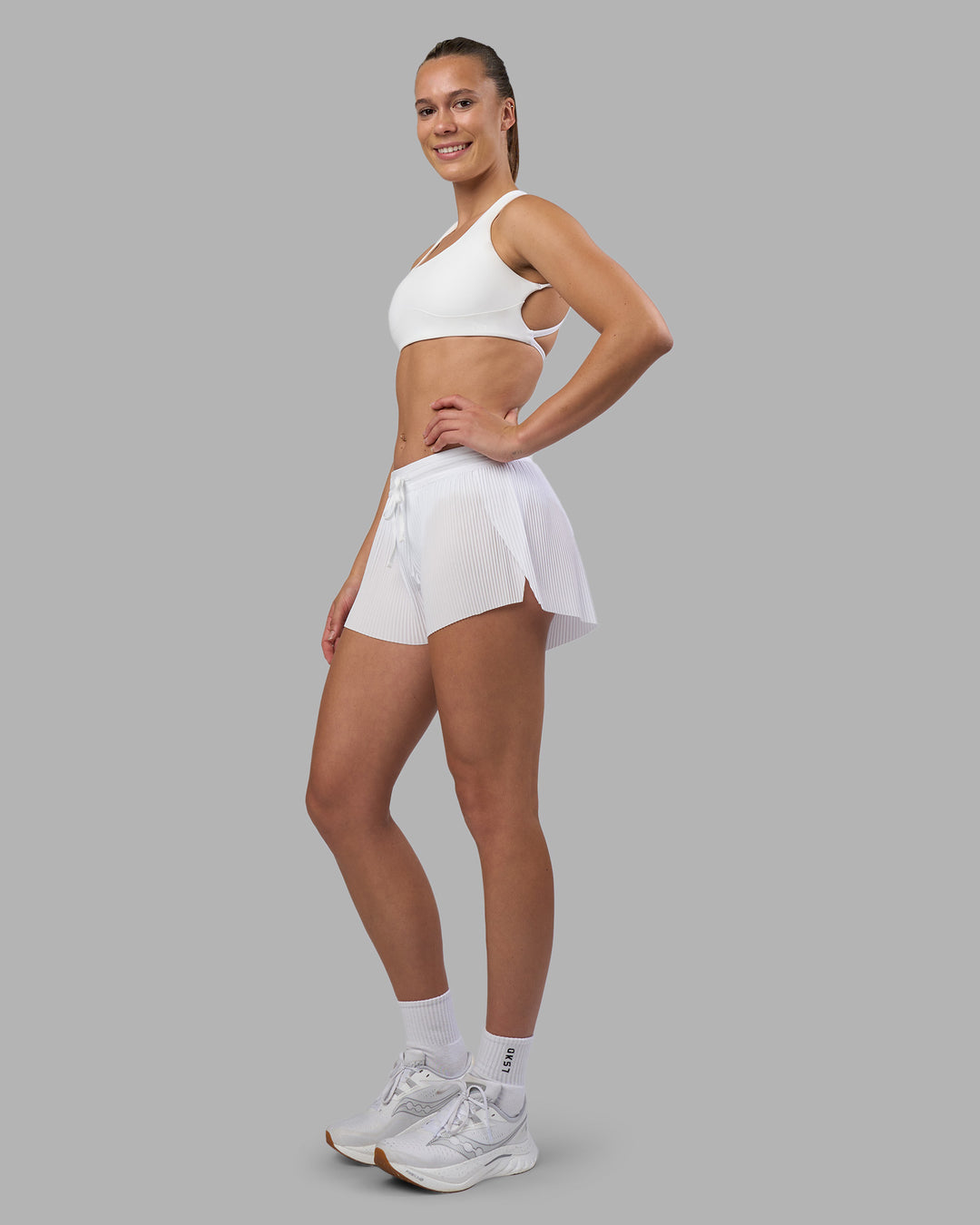 Woman wearing Accelerate 3&quot; Pleated Running Short - White | Model:Charlize | Size:S