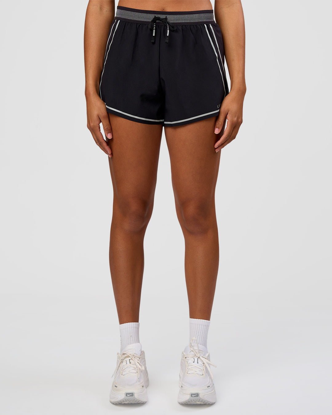 Woman wearing Accelerate 3" Reflective High-Rise Running Short - Black-Reflective | Set:true | Angle:front | Model:Rosie | Size:S