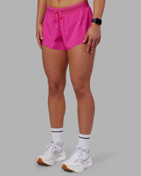 Woman wearing Accelerate 3" Running Short - Ultra Pink | Set:true | Angle:side | Model:Keisha | Size:S