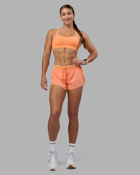 Woman wearing Accelerate 3" Running Short - Cantaloupe | Model:Hannah | Size:S