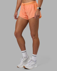 Woman wearing Accelerate 3" Running Short - Cantaloupe | Set:true | Angle:side | Model:Hannah | Size:S