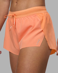Woman wearing Accelerate 3" Running Short - Cantaloupe | Set:true | Angle:closeup | Model:Hannah | Size:S