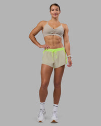 Woman wearing Accelerate 3" Running Short - Lime Glo-Shale Beige | Model:Hannah | Size:S