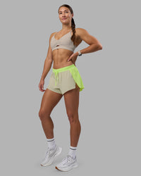 Woman wearing Accelerate 3" Running Short - Lime Glo-Shale Beige | Model:Hannah | Size:S