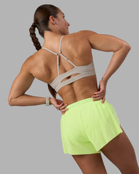 Woman wearing Accelerate 3" Running Short - Lime Glo-Shale Beige | Model:Hannah | Size:S