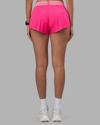Woman wearing Accelerate 3" Running Short - Ultra Pink-Candy Pink | Set:true | Angle:back | Model:Rhiley | Size:S