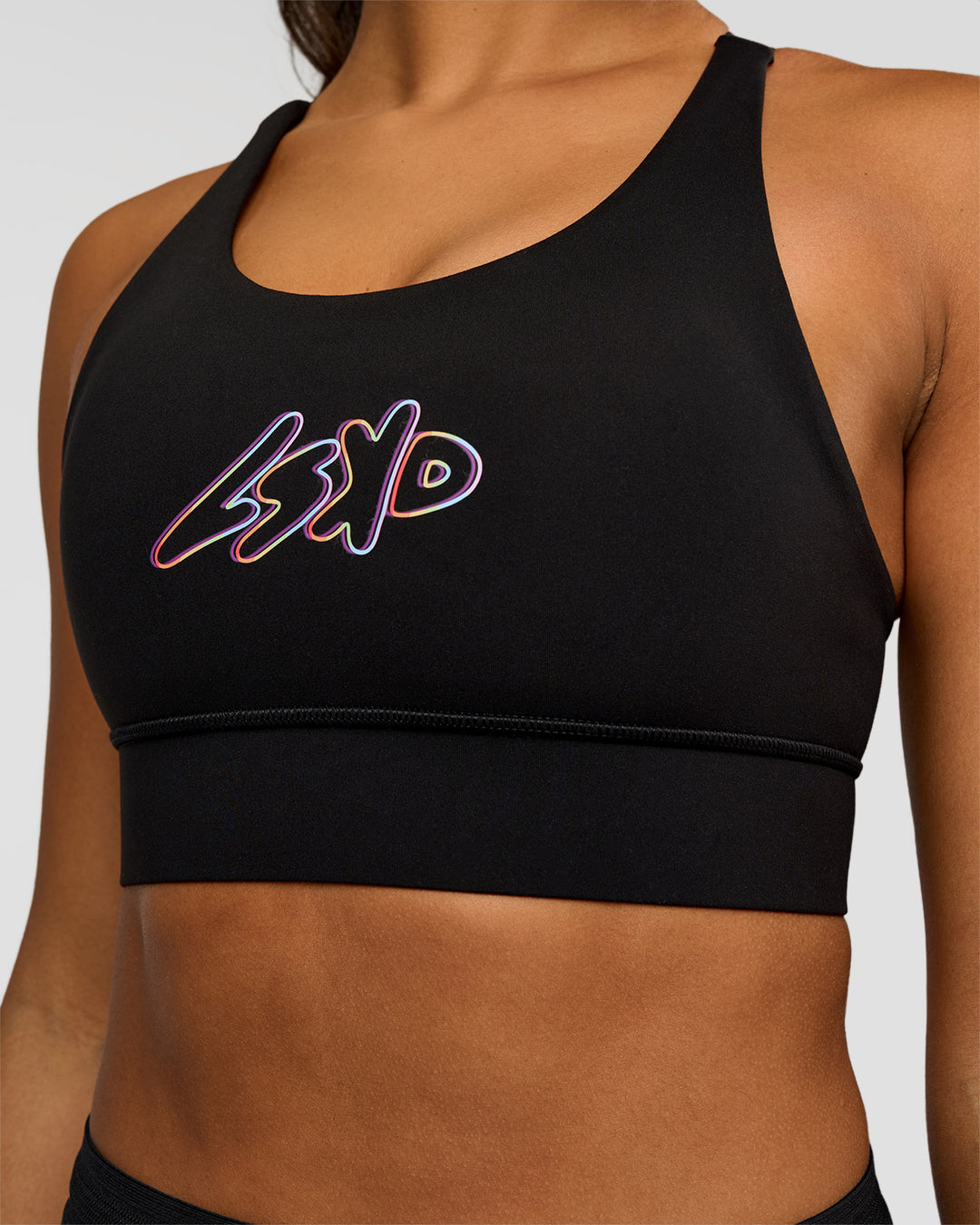Woman wearing Accelerate Graphic Sports Bra - Black-Radiate | Model:Rosie | Size:S