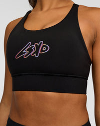 Woman wearing Accelerate Graphic Sports Bra - Black-Radiate | Model:Rosie | Size:S