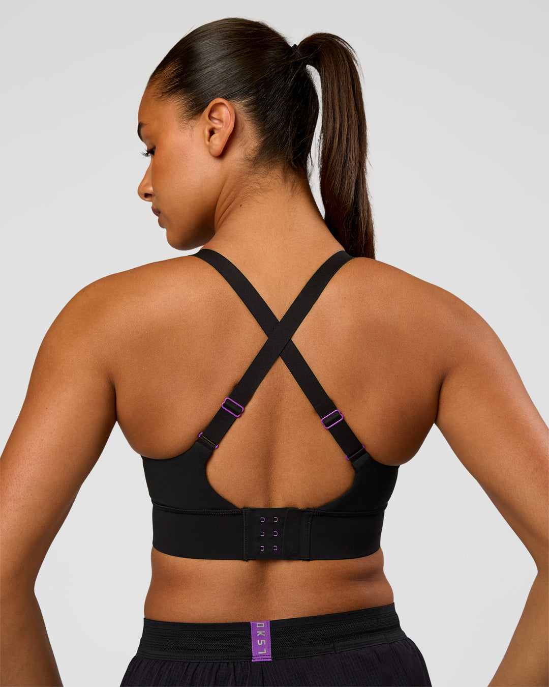 Woman wearing Accelerate Graphic Sports Bra - Black-Radiate | Model:Rosie | Size:S