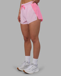 Woman wearing Accelerate 3" High-Rise Running Short - Candy Pink-Marshmallow | Set:true | Angle:side | Model:Keisha | Size:S