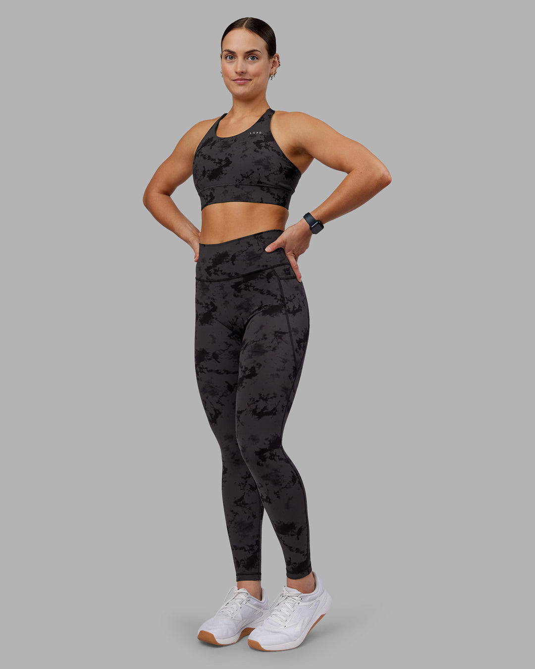 Woman wearing Accelerate Split Strap Sports Bra - Black Tie Dye | Model:Keisha | Size:S