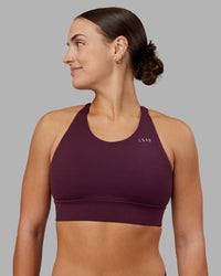 Woman wearing Accelerate Split Strap Sports Bra - Cherry Lacquer | Model:Keisha | Size:S