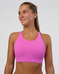 Woman wearing Accelerate Split Strap Sports Bra - Ultra Fuchsia | Model:Amity | Size:S