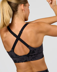 Woman wearing Accelerate Sports Bra - Black Tie Dye | Model:Amity | Size:S