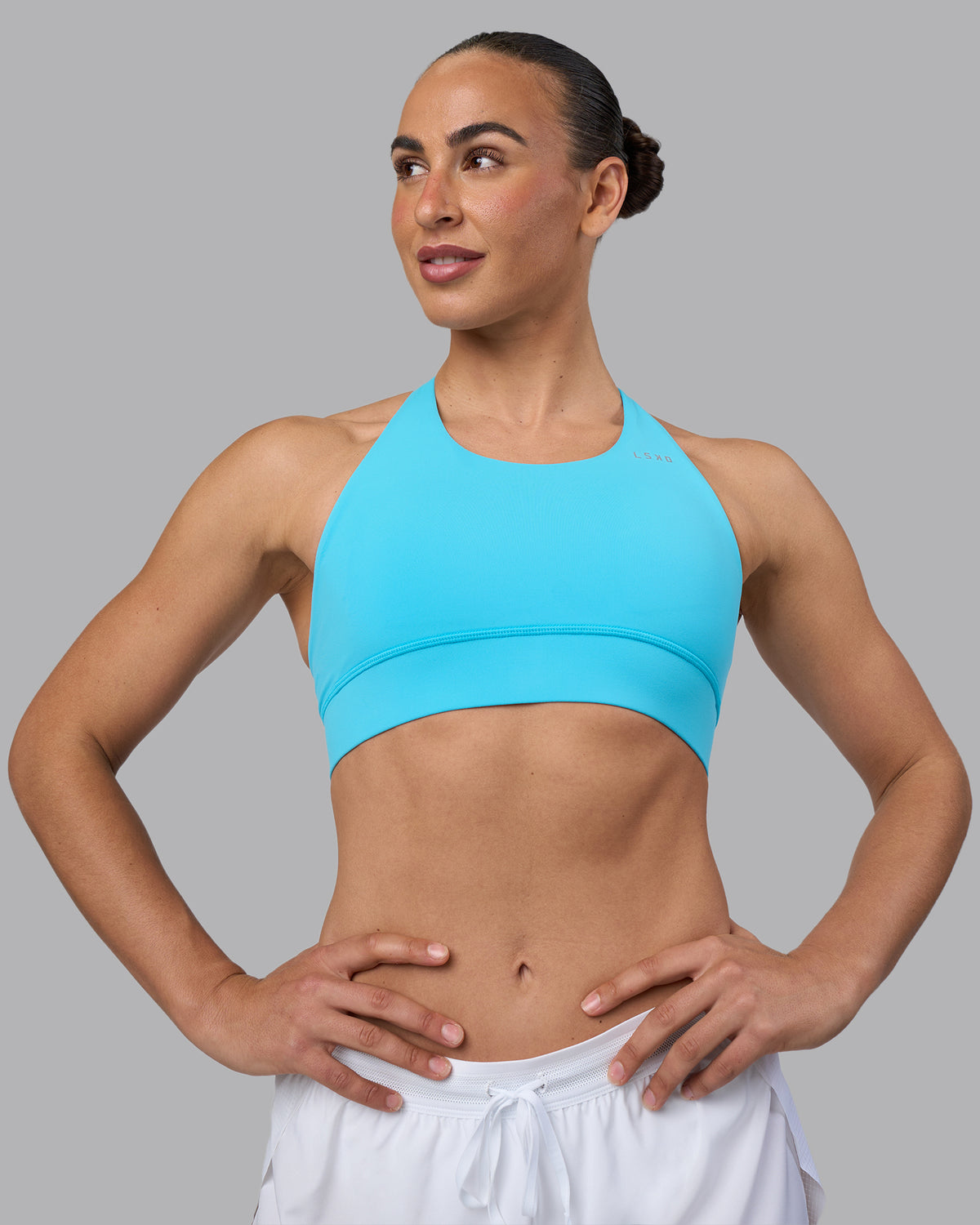 Woman wearing Accelerate Sports Bra - Blue Atoll | Model:Sophie | Size:S