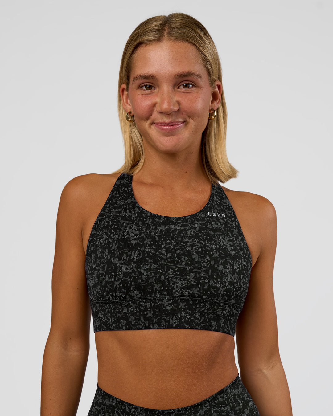 Woman wearing Accelerate Sports Bra - Energy Print Black | Model:Amity | Size:S