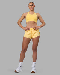 Woman wearing Accelerate Sports Bra - Lemon | Model:Sophie | Size:S | Thumbnail Index: 0