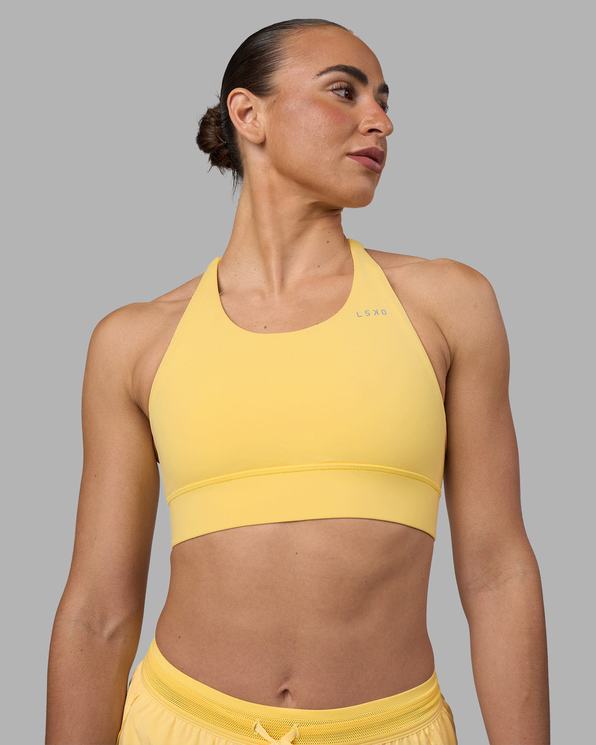 Woman wearing Accelerate Sports Bra - Lemon | Model:Sophie | Size:S
