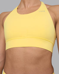 Woman wearing Accelerate Sports Bra - Lemon | Set:true | Angle:closeup | Model:Sophie | Size:S | Thumbnail Index: 6