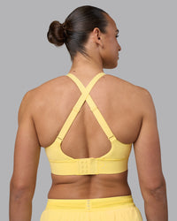 Woman wearing Accelerate Sports Bra - Lemon | Set:true | Angle:back | Model:Sophie | Size:S | Thumbnail Index: 5