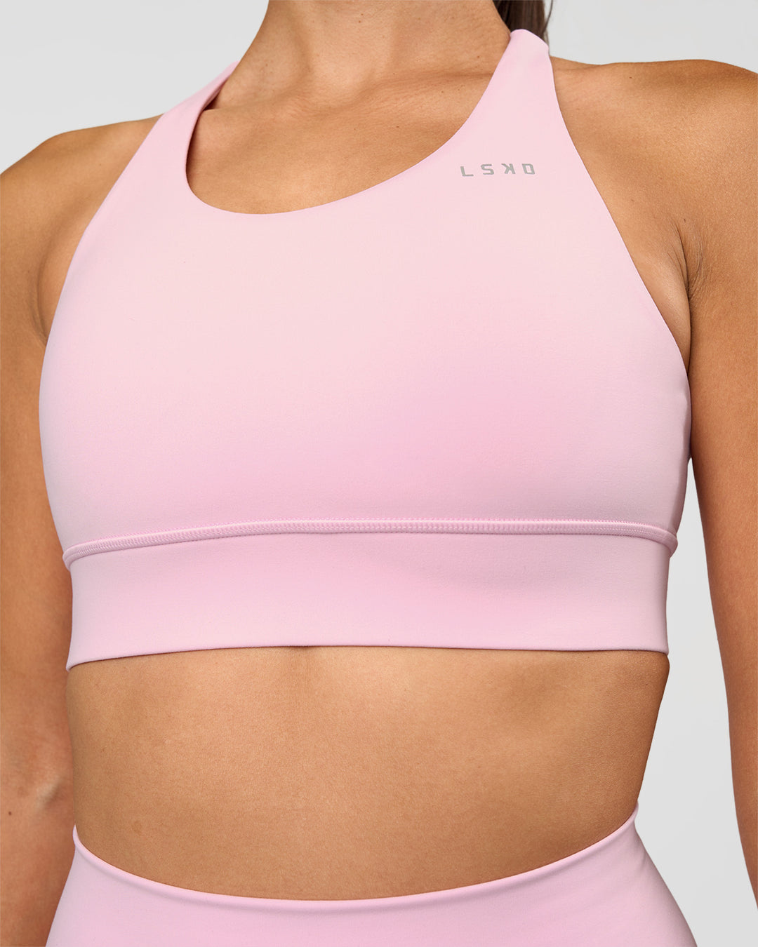 Woman wearing Accelerate Sports Bra - Marshmallow | Set:true | Angle:closeup | Model:Rhiley | Size:S