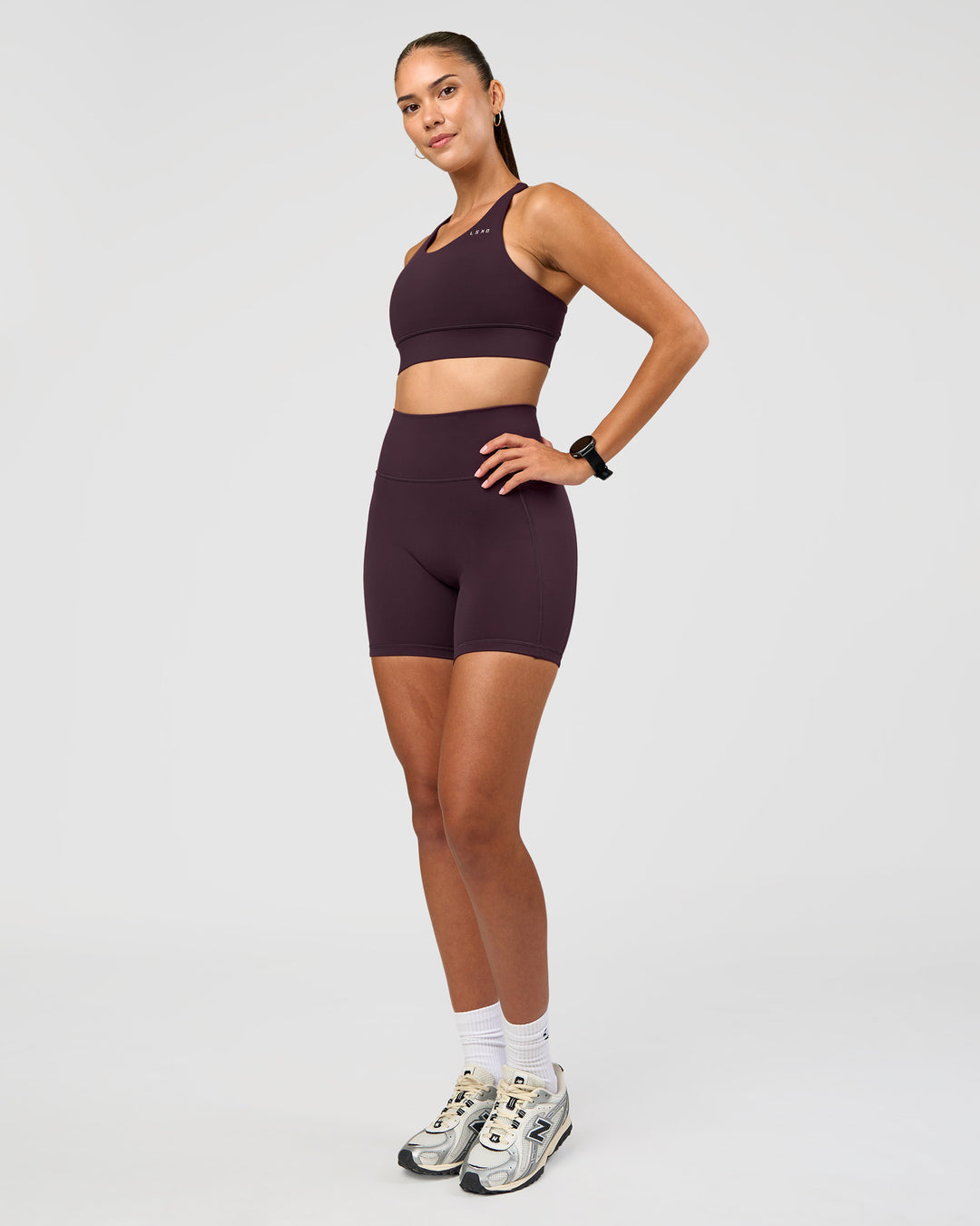 Woman wearing Accelerate Sports Bra - Midnight Plum | Model:Rhiley | Size:S
