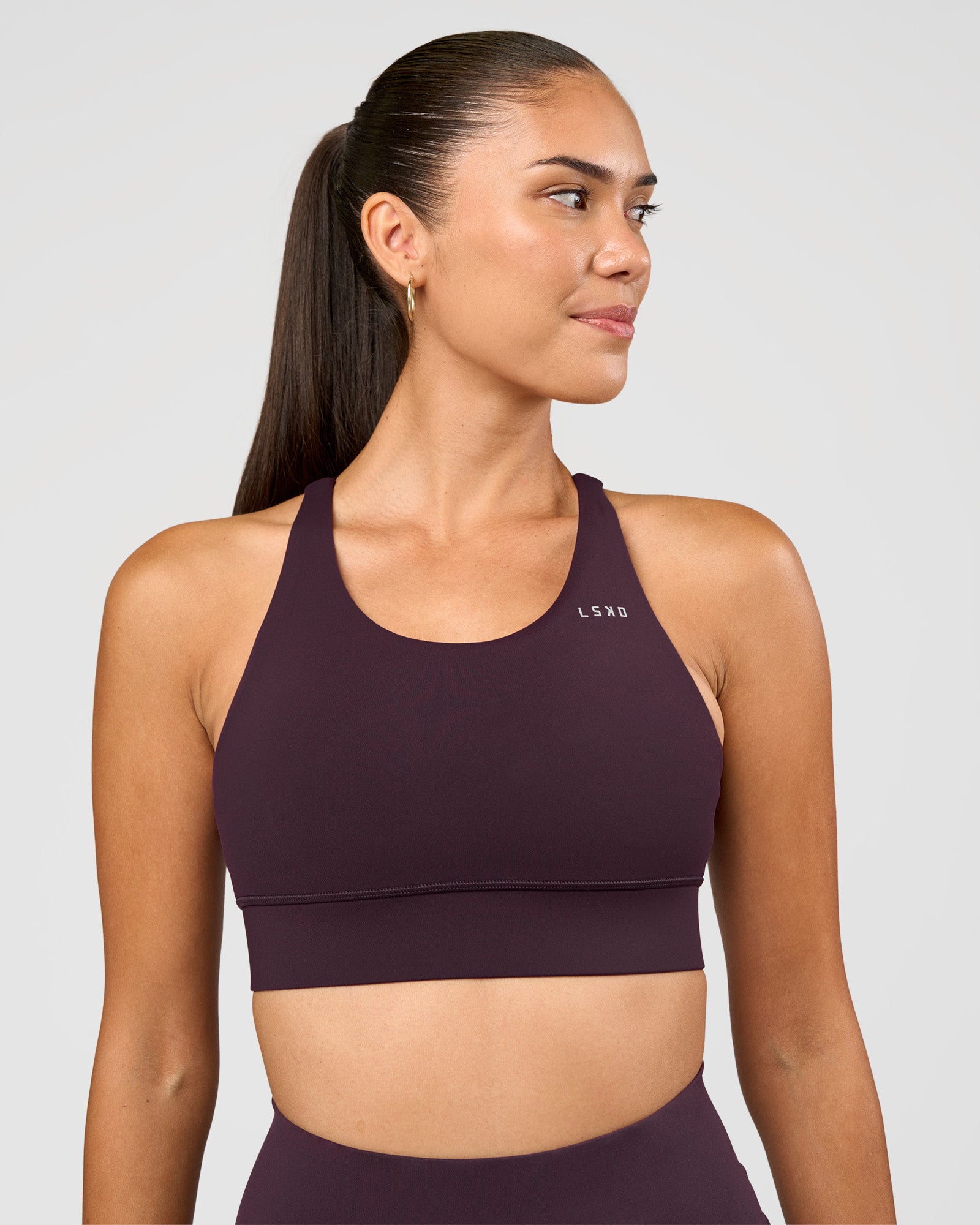 Woman wearing Accelerate Sports Bra - Midnight Plum | Set:true | Angle:front | Model:Rhiley | Size:S