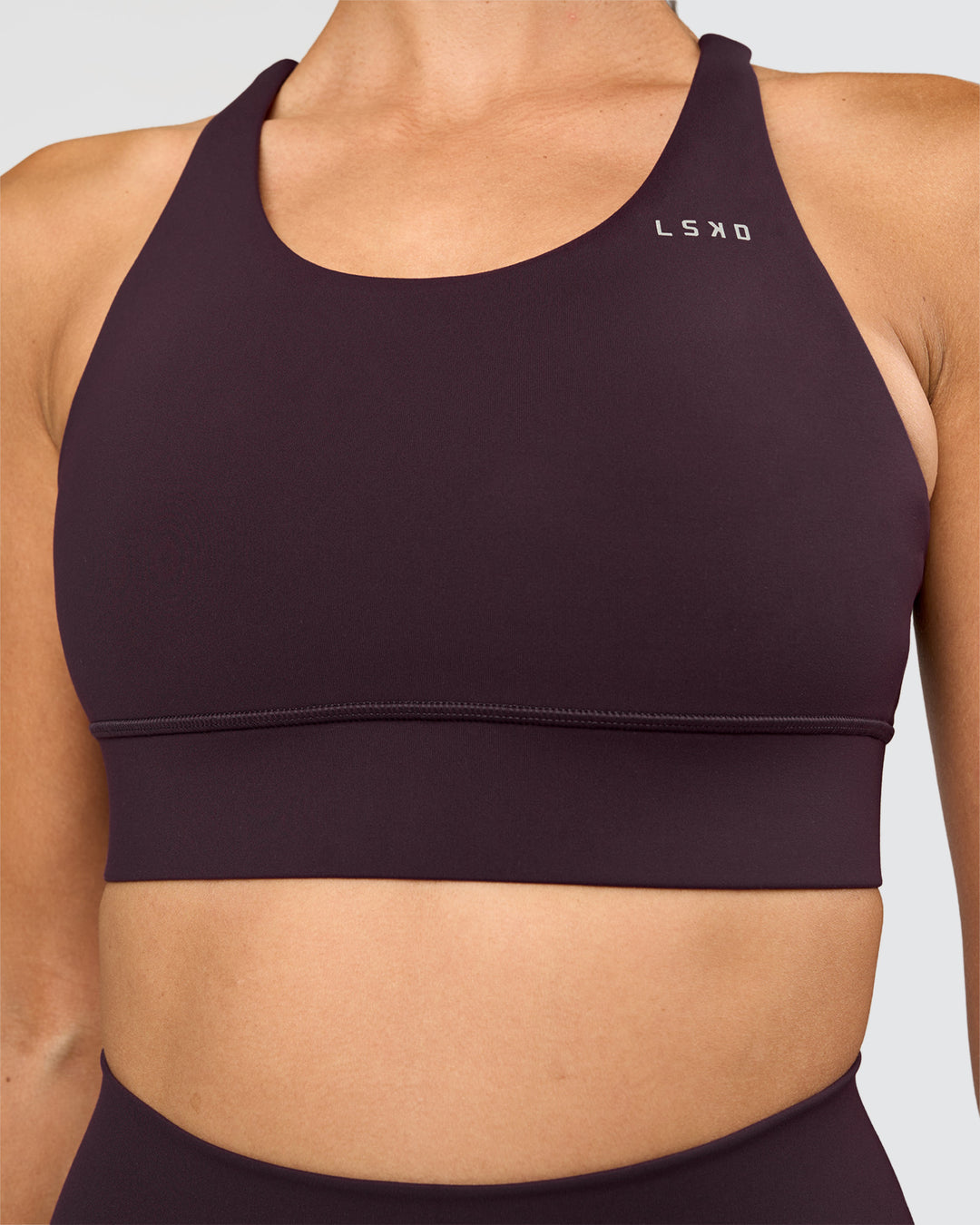 Woman wearing Accelerate Sports Bra - Midnight Plum | Set:true | Angle:closeup | Model:Rhiley | Size:S