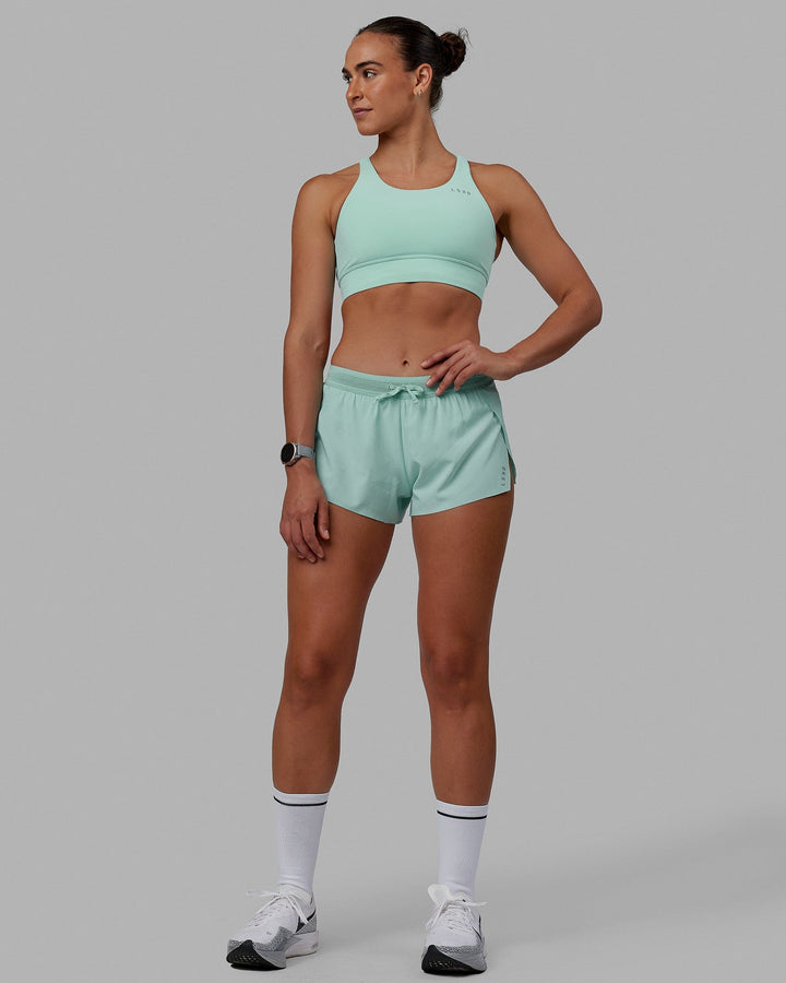 Woman wearing Accelerate Sports Bra - Pastel Turquoise