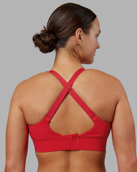 Woman wearing Accelerate Sports Bra - Scarlet | Set:true | Angle:back | Model:Keisha | Size:S