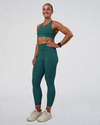 Woman wearing Accelerate Sports Bra - Transformative Teal | Model:Sav | Size:S