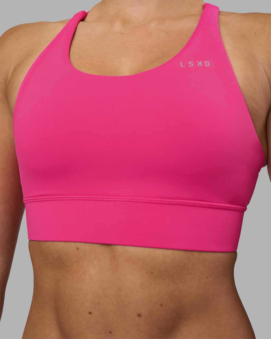 Woman wearing Accelerate Sports Bra - Ultra Pink | Model:Hannah | Size:S