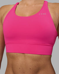 Woman wearing Accelerate Sports Bra - Ultra Pink | Model:Hannah | Size:S