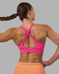 Woman wearing Accelerate Sports Bra - Ultra Pink | Model:Hannah | Size:S