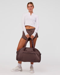 Woman wearing AeroFLX+ Long Sleeve Skimmer Half Zip - White/White | Model:Amity | Size:S