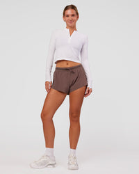 Woman wearing AeroFLX+ Long Sleeve Skimmer Half Zip - White/White | Model:Amity | Size:S