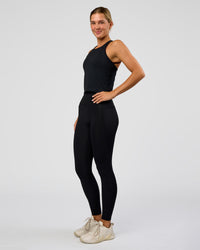Woman wearing AeroFLX+ Seamless Flow Skimmer Tank - Black Marl | Model:Amity | Size:S
