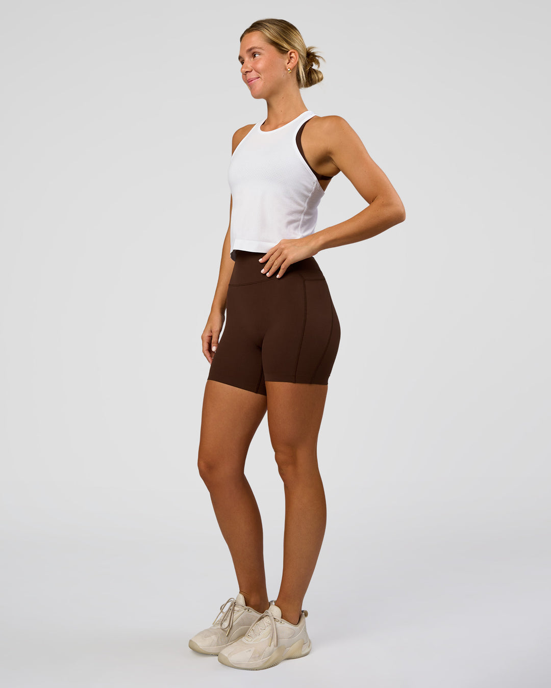 Woman wearing AeroFLX+ Seamless Flow Skimmer Tank - White/White | Model:Amity | Size:S