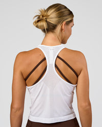 Woman wearing AeroFLX+ Seamless Flow Skimmer Tank - White/White | Model:Amity | Size:S
