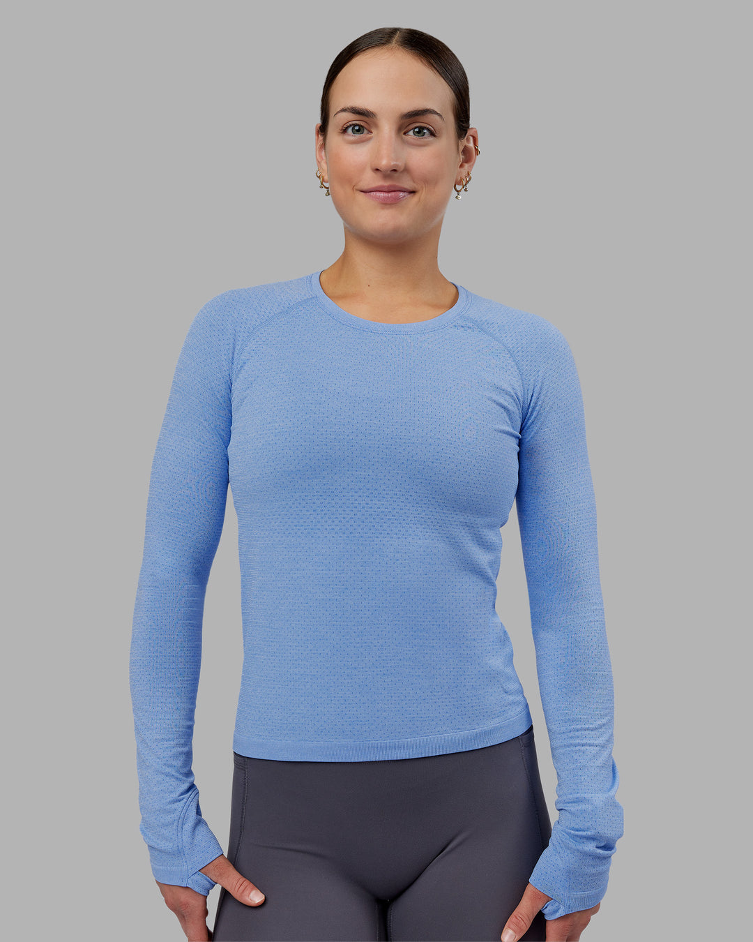 Woman wearing AeroFLX+ Seamless Long Sleeve Tee - Cornflower Blue Marl | Model:Keisha | Size:S