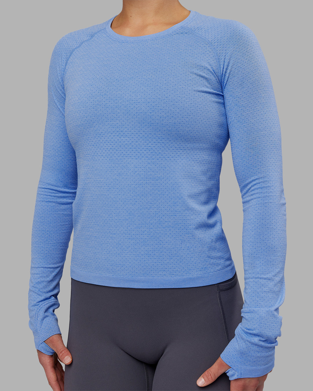 Woman wearing AeroFLX+ Seamless Long Sleeve Tee - Cornflower Blue Marl | Model:Keisha | Size:S